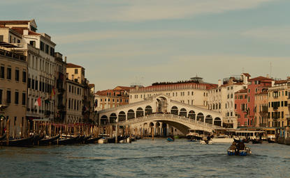 Venetian buildings and bridge reflected in the Grand Canal at Aman Venice, Italy.