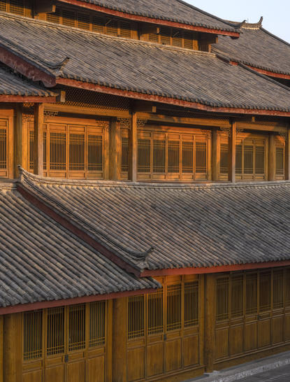 Exterior of Amandayan showing traditional Chinese architecture with tiered roofs and wooden window frames.