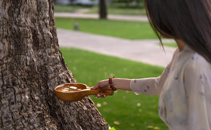 Woman feeding a squirrel at Amanyangyun, China.