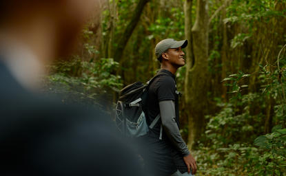 Forager gathering wild ingredients during a guided woodland experience at Amanera resort.