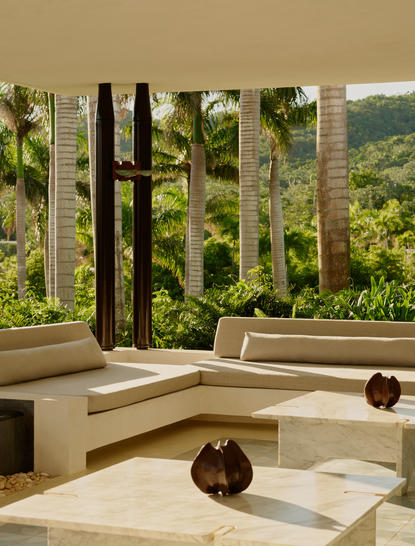 Amanera resort welcome lobby lounge with sculptural seating and views across Dominican hillsides.