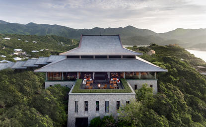 Amanoi resort's central pavilion overlooks verdant hills and coastal waters in Vietnam.