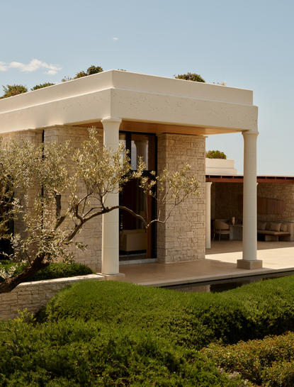 Deluxe pool pavilion with stone exterior and olive tree at Amanzoe resort, Greece.