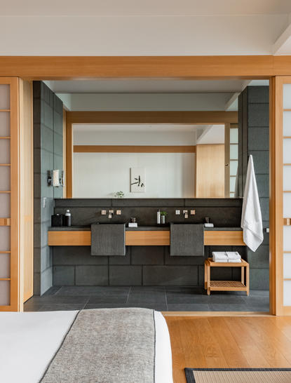 Suite bathroom with dual vanity and garden view at Aman Tokyo hotel.