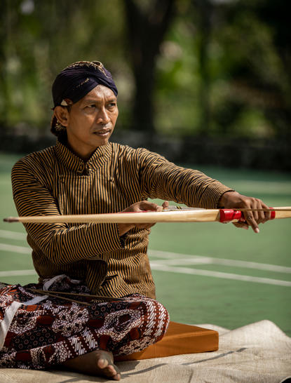 Wellness instructor demonstrating jemparingan practice at Amanjiwo in Central Java, Indonesia.