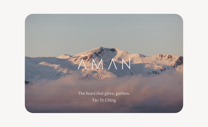 Amangani gift card featuring snow-capped mountain peaks at sunrise with muted tones.