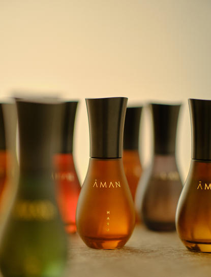 Aman Tokyo fragrance bottles arranged in a row, displaying the Aman Essentials collection.