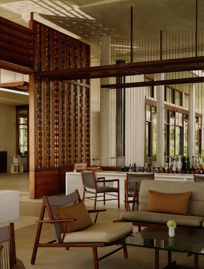 Bar lounge at Amanera resort in the Dominican Republic, featuring mid-century furniture and wooden screens.