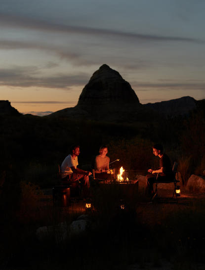 S'mores pavilion at dusk, Amangiri resort, with glowing fire beneath desert rock formations.