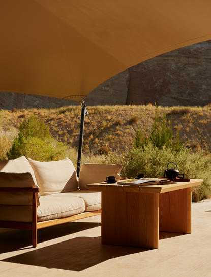 Breakfast pavilion at Amangiri with lounge chair and desert landscape view.