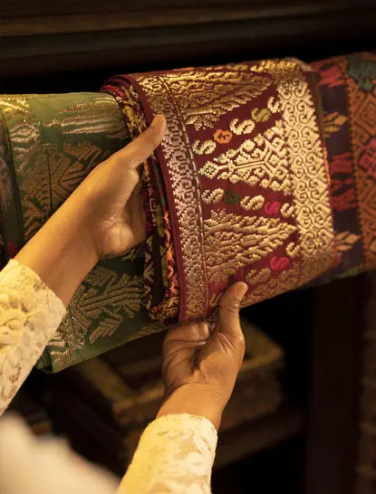 Hand holding a woven rattan box at Amandari, Ubud, Bali.