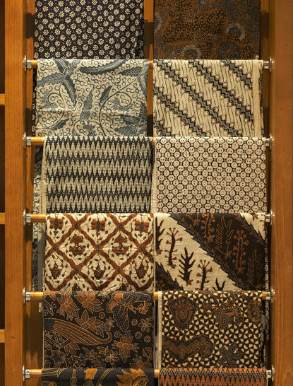 Batik textile samples displayed in wooden frame at Amanjiwo resort, Central Java.