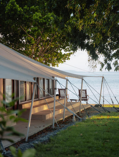 Amanwana accommodation pavilion with wooden deck and landscaped gardens.