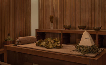 Spa treatment room at Amanyangyun with wooden walls, massage beds and soft lighting.