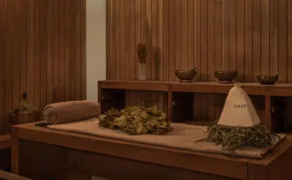 Spa treatment room at Amanyangyun with wooden walls, massage beds and soft lighting.