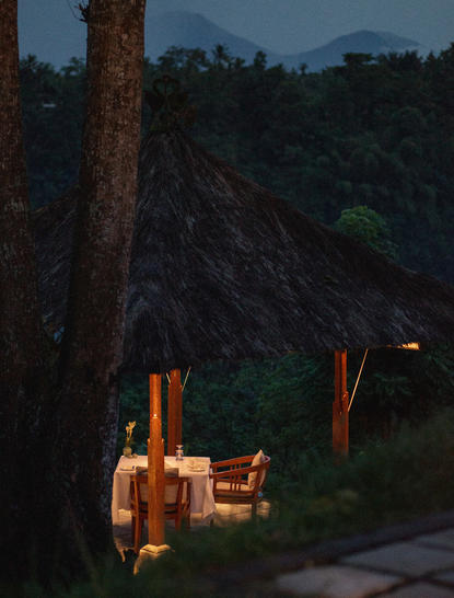 Dining bale set on a clifftop at dusk, Amandari resort, Ubud, Bali.