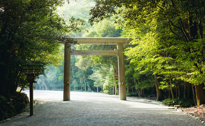 Traditional torii gate at Ise Jingu Shrine near Amanemu, framed by verdant woodland.
