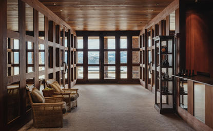 Spa wellness reception at Amangani with latticed doors, wooden beams and seating area overlooking mountains.
