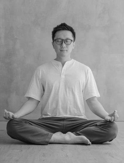 Guest in meditation pose at Amanjiwo resort, black and white photograph.