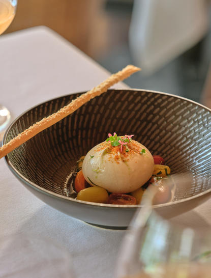 Tomato salad with buffalo mozzarella, presented in a wok at Amanpuri resort's Arva dining venue.