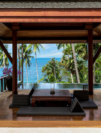 Pavilion with ocean views at Amanpuri resort, open-sided structure with wooden beams framing sea and tropical garden beyond.