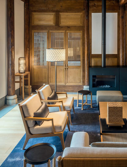 Antique villa living room at Amanyangyun with wooden furniture, blue accents, and traditional Chinese architectural details.