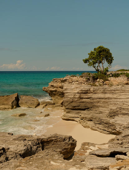 Ocean cove pavilion at Amanyara with turquoise waters and rocky shoreline, Turks and Caicos.