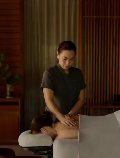 Wellness therapist performing a massage treatment at Amanyara resort.