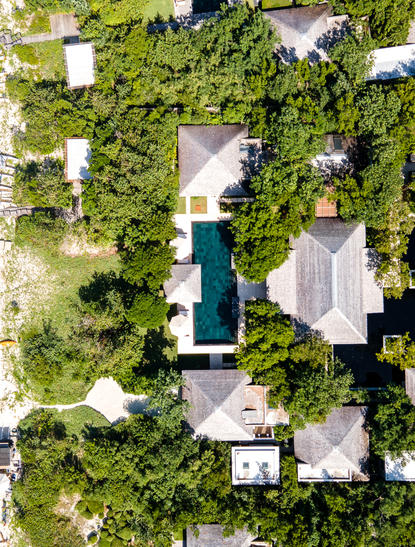 Aerial view of Amanyara villa showing principal bedroom nestled amongst lush tropical vegetation and swimming pool.