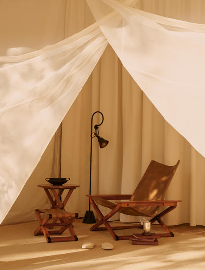 Sheer white fabric draped across wooden tent frame at Aman-i-Khas, with traditional seating inside.