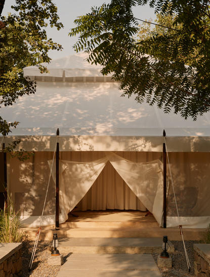 Canvas tent with four-poster bed frame at Aman-i-Khas, overlooking the Yamuna River at sunrise.
