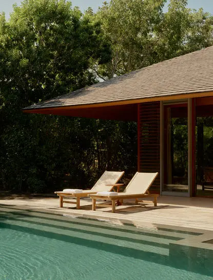 Pool pavilion with teak loungers at Amanyara resort, Turks and Caicos Islands.