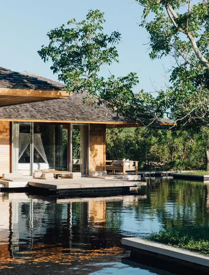 Four-bedroom beach sala villa at Amanyara overlooking a lagoon at dusk, Turks and Caicos.