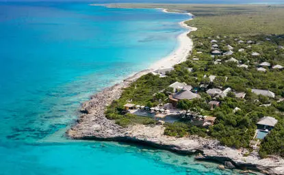 Aerial view of Amanyara's white sand beach meeting turquoise waters along the Turks and Caicos coastline.