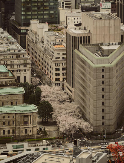 Aerial view of Aman Tokyo's surrounding streets with modernist buildings and pedestrian crossings in central Tokyo.