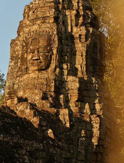 Stone face carved into temple tower at Amansara, Cambodia.