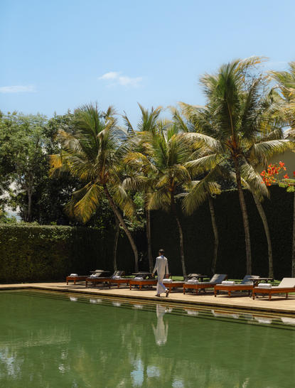Wellness spa pool at Amangalla framed by palm trees and tropical vegetation in Sri Lanka.