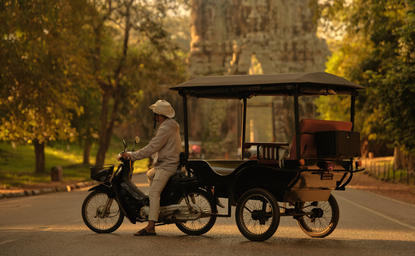 Tuk-tuk parked at Amansara's entrance for Angkor Wat temple tours at dusk.