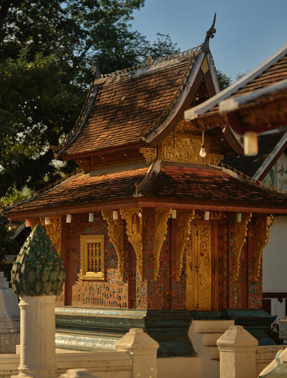 Golden wooden temple pavilion at Wat Xieng Thong, Luang Prabang, featured in Amantaka's temple and city tour.