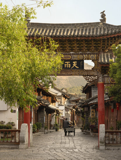 Traditional courtyard at Amandayan with Ming Dynasty architecture, red lanterns, and stone pathways in Lijiang Old Town.