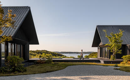 Amanemu resort exterior with two modern pavilions overlooking the Japanese coastline at dusk.