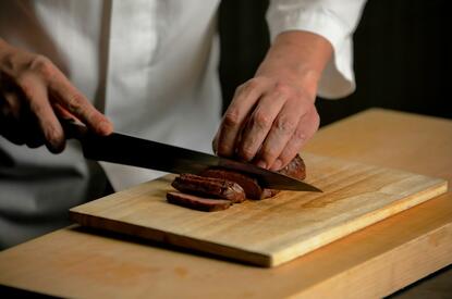 Chef preparing wagyu beef at Aman Kyoto's Takaan dining venue.