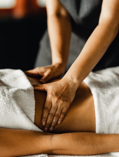 Therapist performing Thai massage on guest's leg at Amanpuri wellness spa.