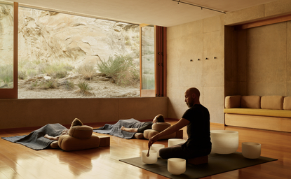 Guest participating in sound bowl wellness experience at Amangiri resort spa.