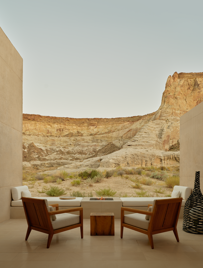 Two chairs and a side table on the back patio of Girijaala Suite at Amangiri, facing desert rock formations.