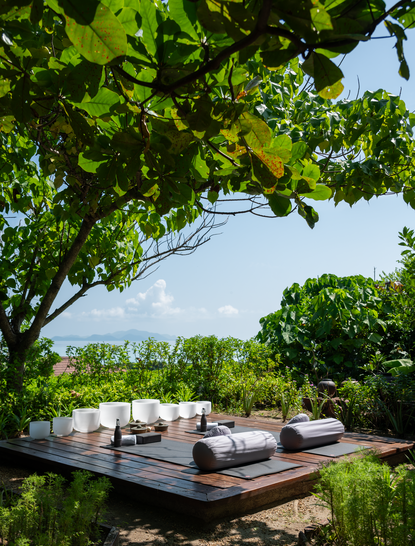 Yoga platform shaded by trees in the healing garden at Amanpulo, Philippines.