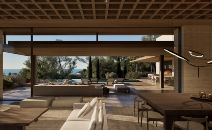 Amanruya interior with open-plan living space overlooking terraced gardens through floor-to-ceiling windows.