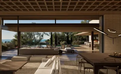 Amanruya interior with open-plan living space overlooking terraced gardens through floor-to-ceiling windows.
