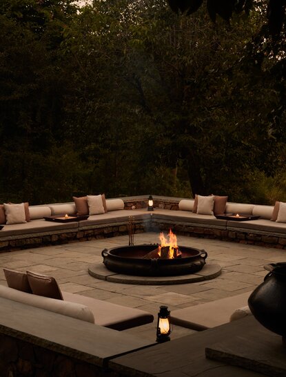 Fire pit with curved seating at Aman-i-Khas, India, at dusk.