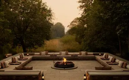 Fire pit with curved seating at Aman-i-Khas, India, at dusk.